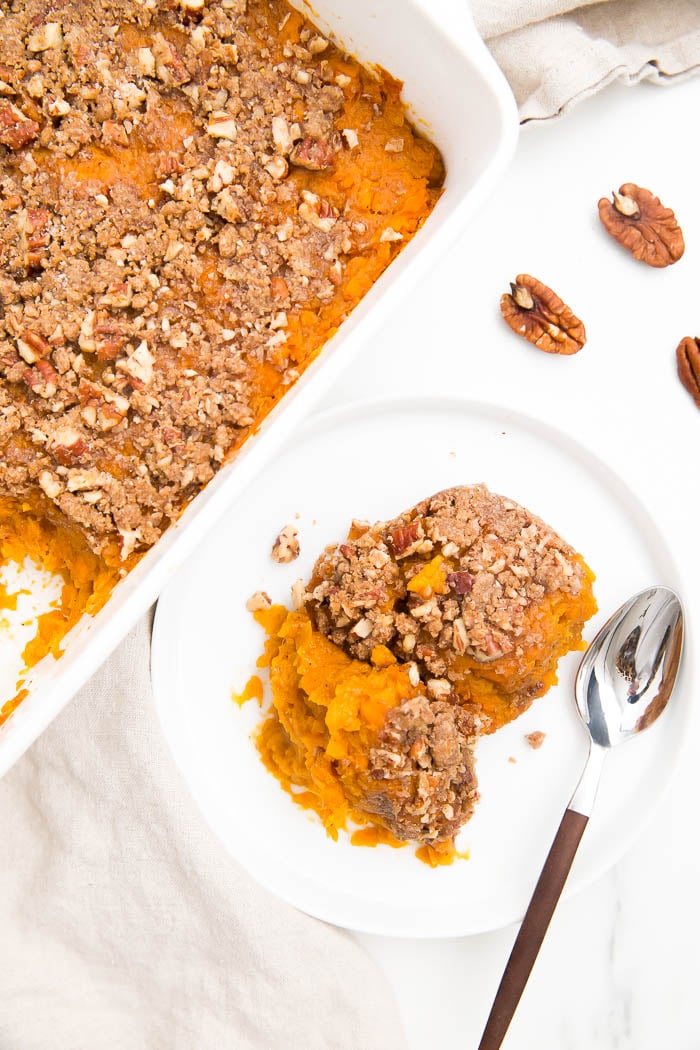 Sweet potato casserole scooped out onto a white plate