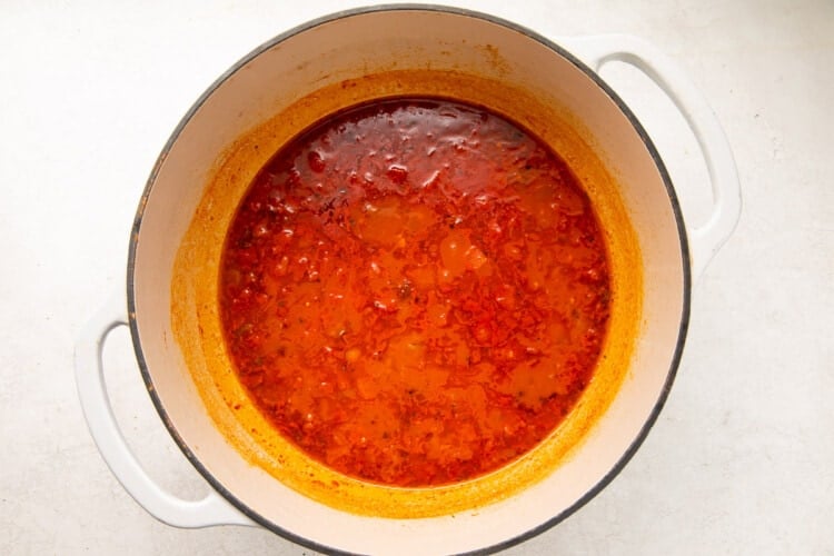 Clam juice, tomatoes, white wine, and water in a large pot