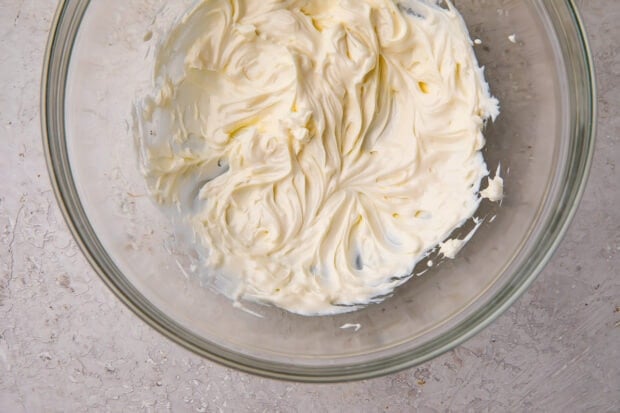 Softened cream cheese in a glass bowl