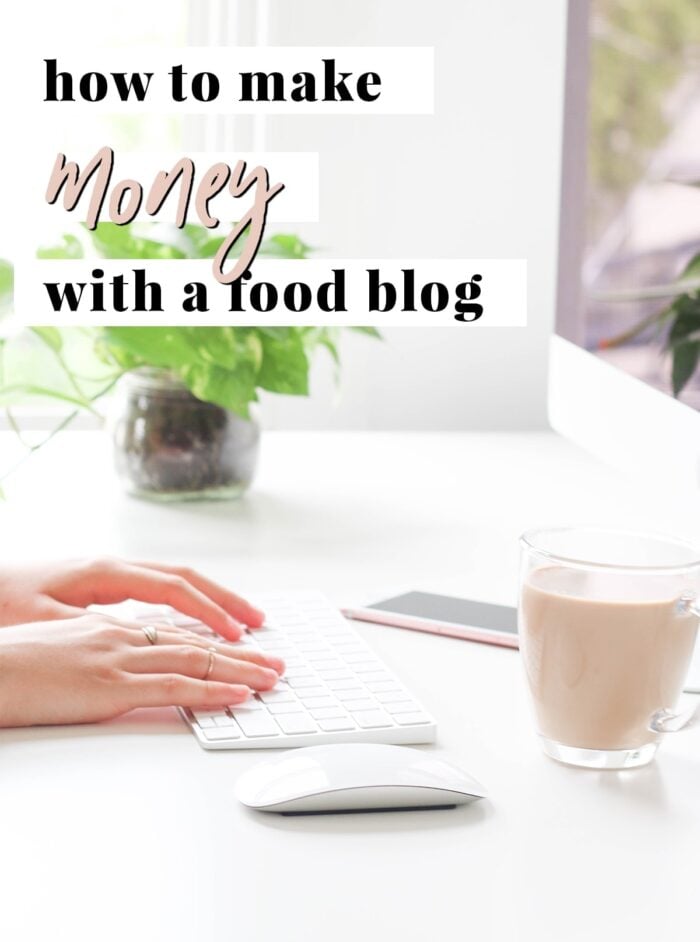 Graphic for how to make money with a food blog. A pair of hands typing on a white iMac keyboard, with a white Apple mouse, a clear glass mug of coffee, and the corner of an iMac in the frame.