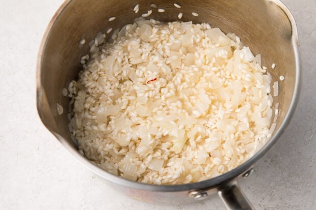 Risotto rice in a silver saucepan