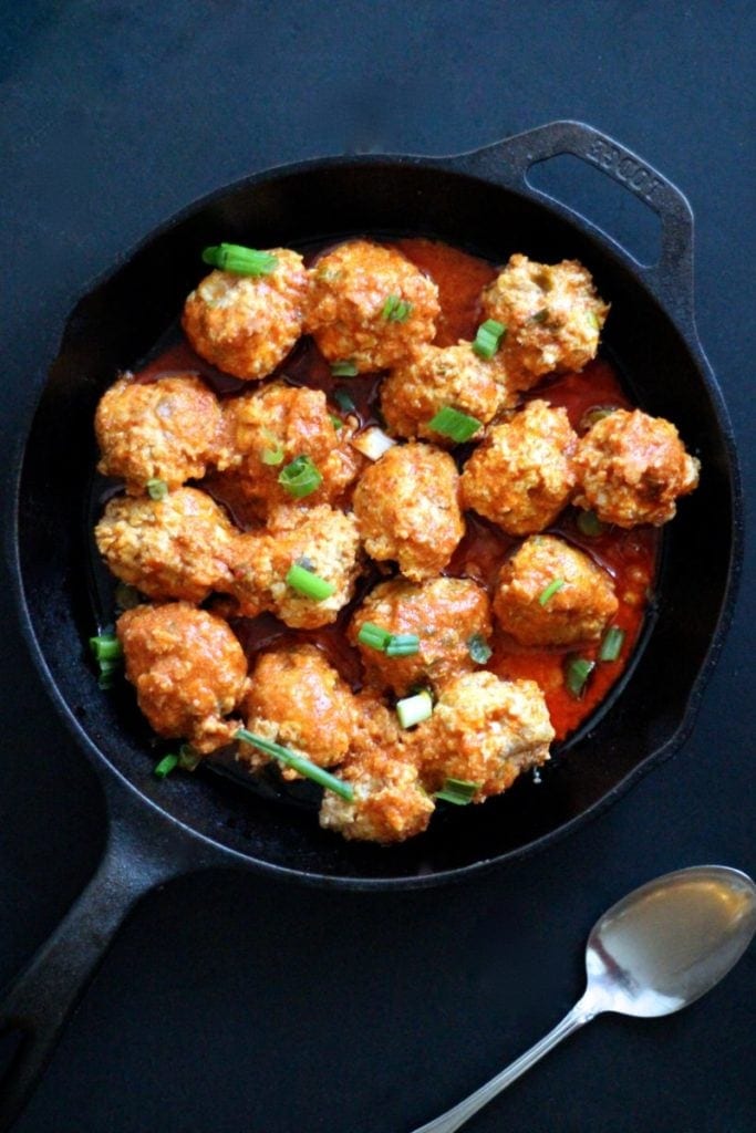 A cast iron skillet holding low carb meatballs cooked in the Instant Pot