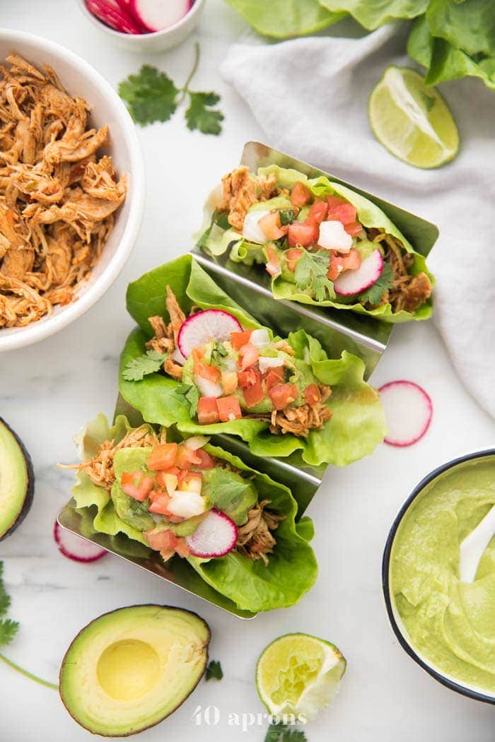 Three lettuce wraps in a taco holder