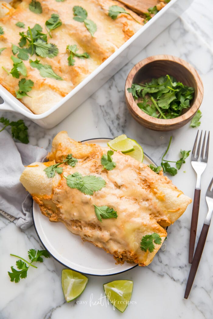 Creamy chicken enchiladas on a white plate