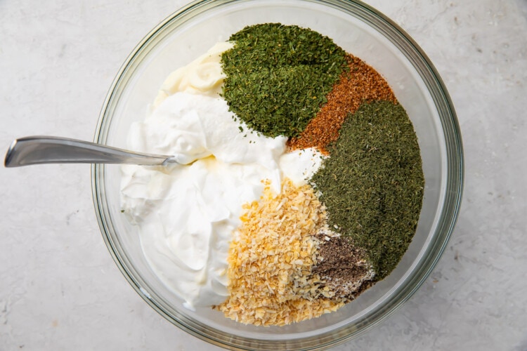 Dill dip ingredients in a large glass mixing bowl