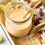 Fish taco sauce in a glass jar with a spoon