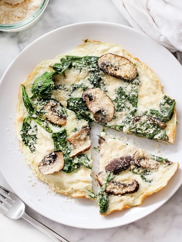 Spinach and mushroom frittata on a white plate