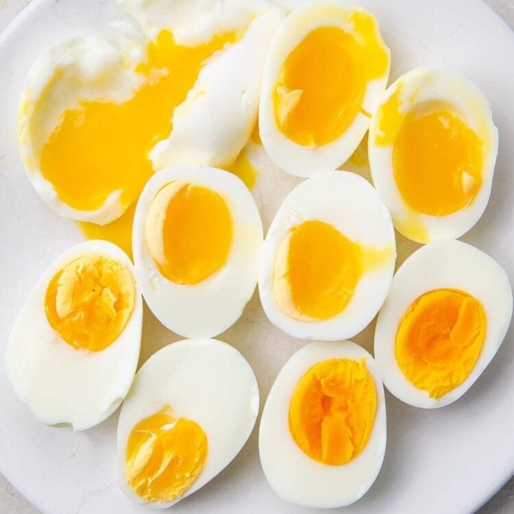 Various halved Instant Pot eggs on a white plate