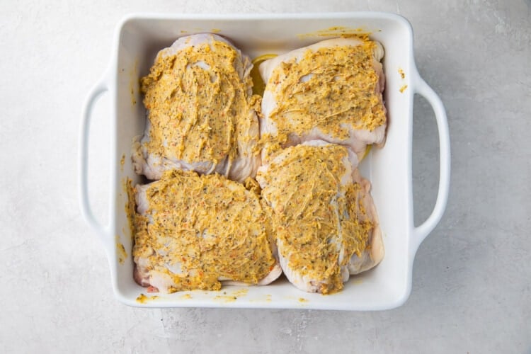 Lemon pepper chicken thighs in a baking dish