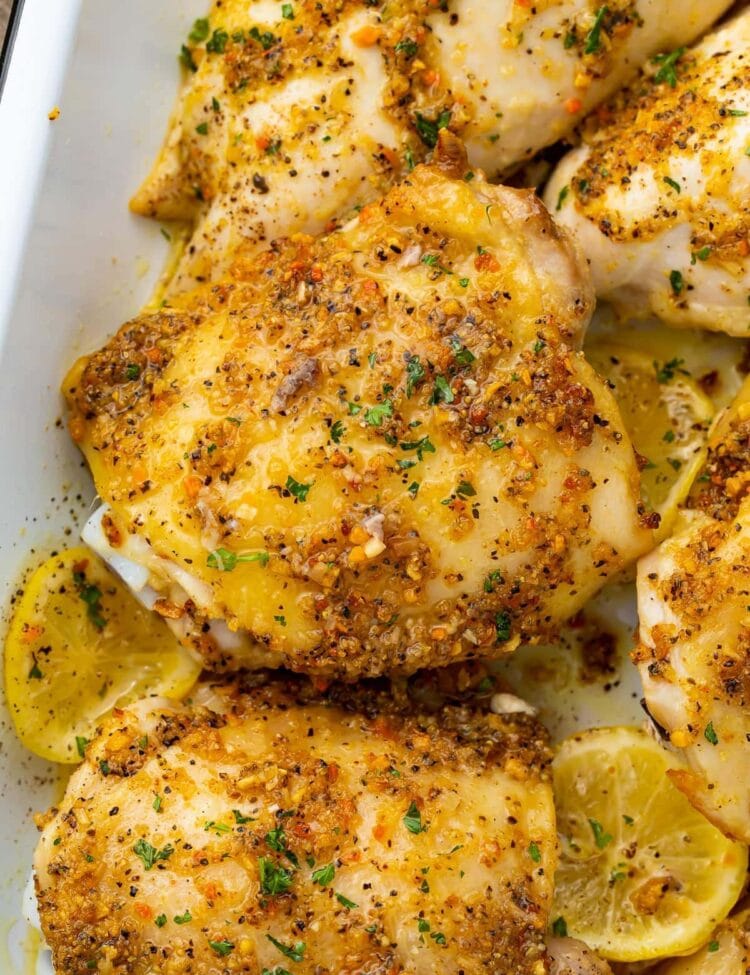 Lemon pepper chicken thighs in a white baking dish
