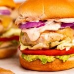 Close-up image of chicken burgers with chipotle aioli.