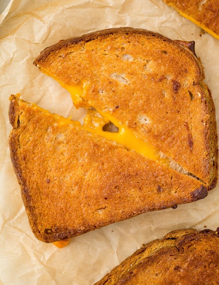 Close up of an air fried grilled cheese sandwich on parchment paper