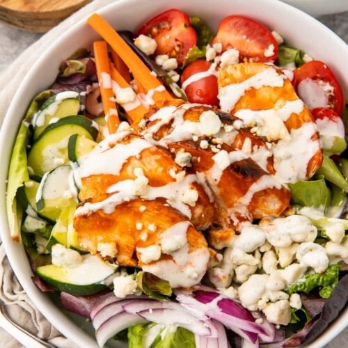 Overhead view of buffalo chicken salad in a white bowl