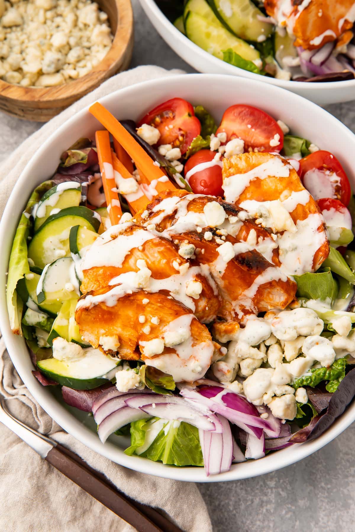 Overhead view of buffalo chicken salad in a white bowl
