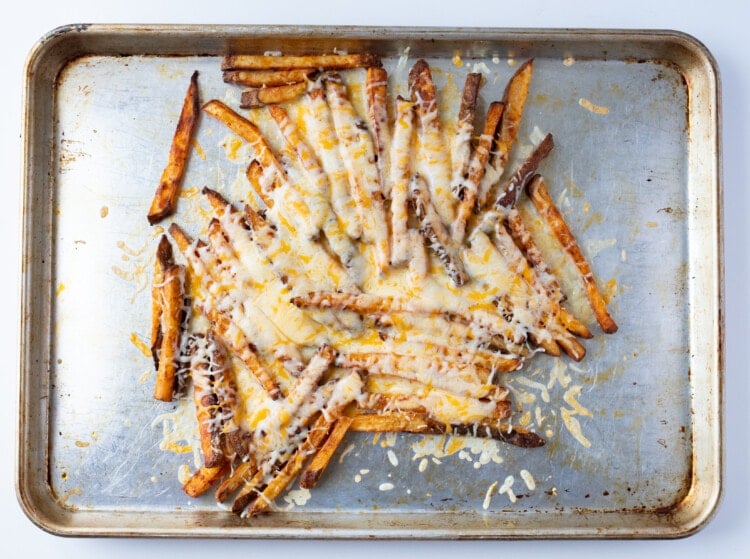 Fries on sheet pan with melted cheese