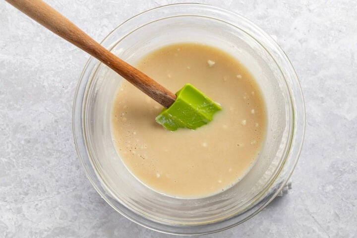 Prepared cobbler crust butter in a glass mixing bowl with a silicone spatula.