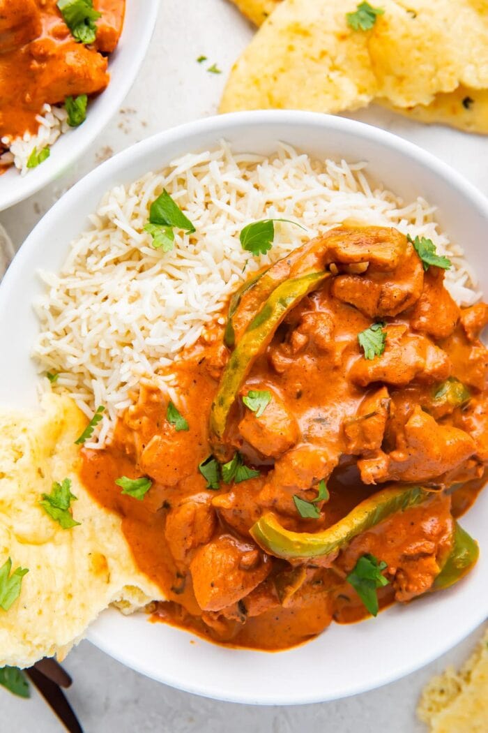 Instant Pot Chicken Tikka Masala in a bowl with basmati rice and naan