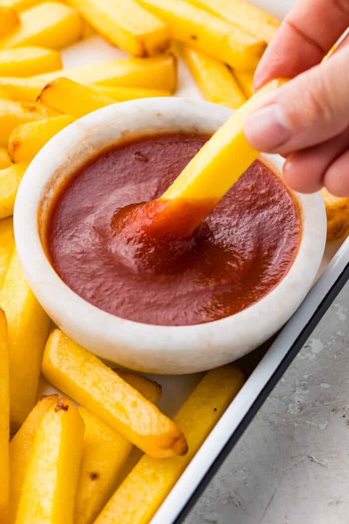 Fry dipped into keto ketchup in a small bowl