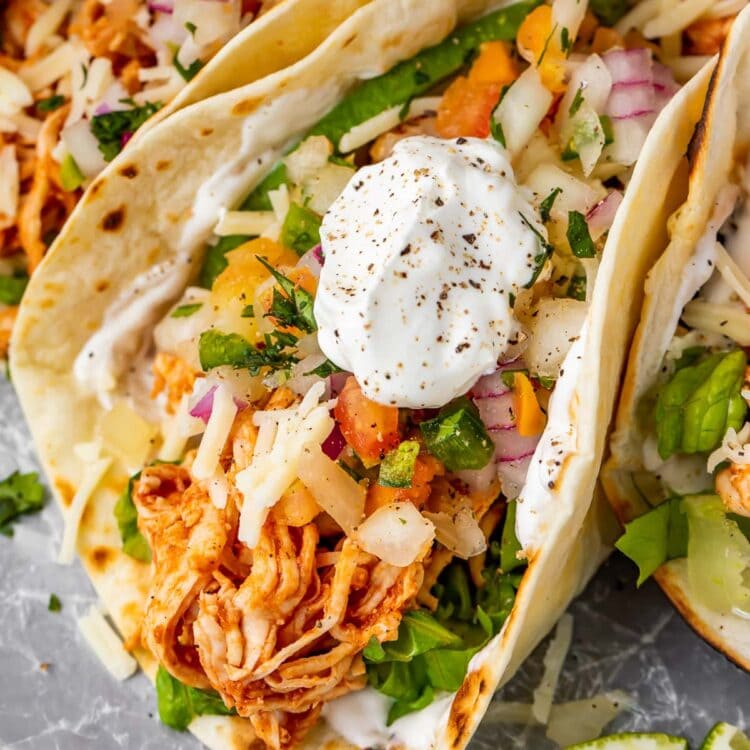 Close up of a shredded chicken taco with sour cream