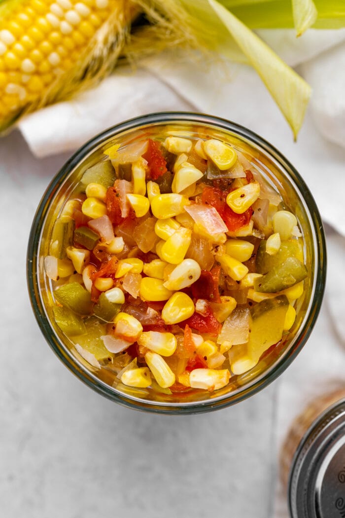overhead image of corn relish with fresh corn on the side