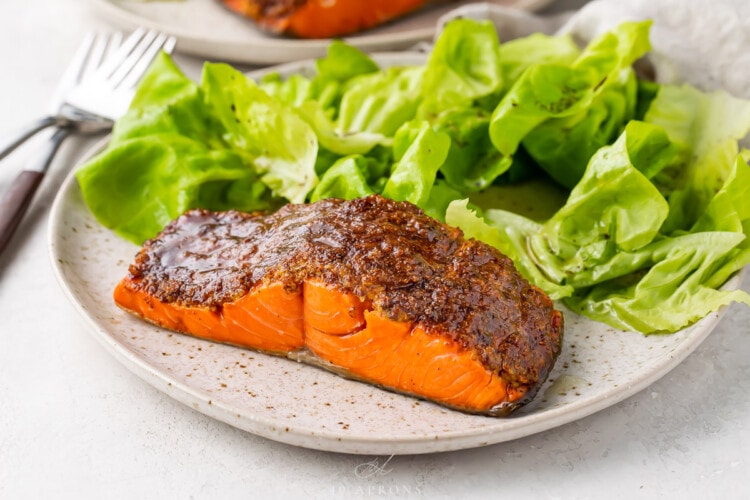 Plated air fryer salmon with a small green salad