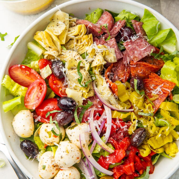 Antipasto salad in a large white bowl, taken from above.