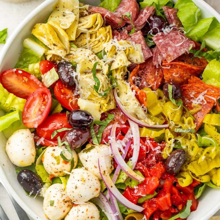 Antipasto salad in a large white bowl, taken from above