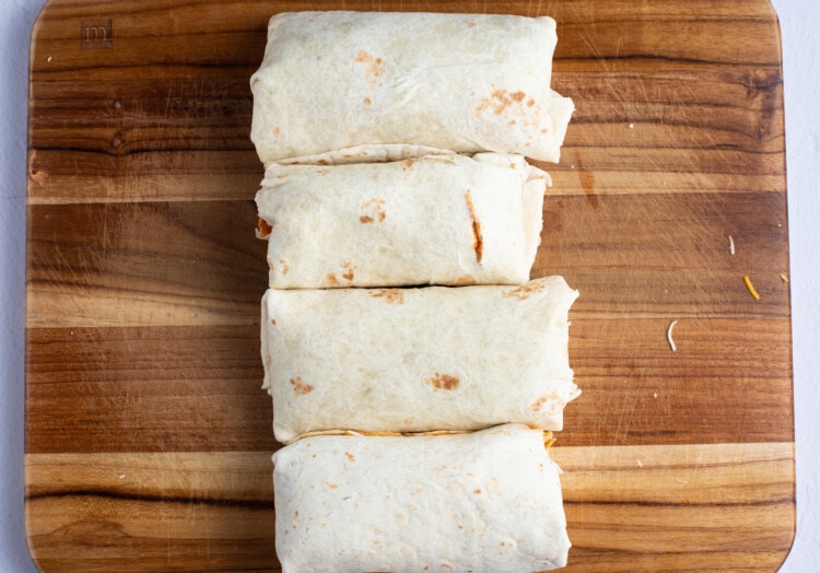 Rolled burritos on wooden board