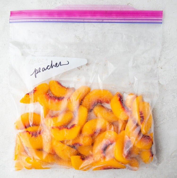 Frozen peach slices in a zippered freezer bag