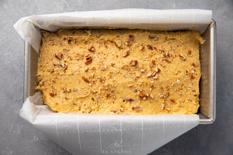 Keto banana bread batter in loaf pan lined with parchment paper