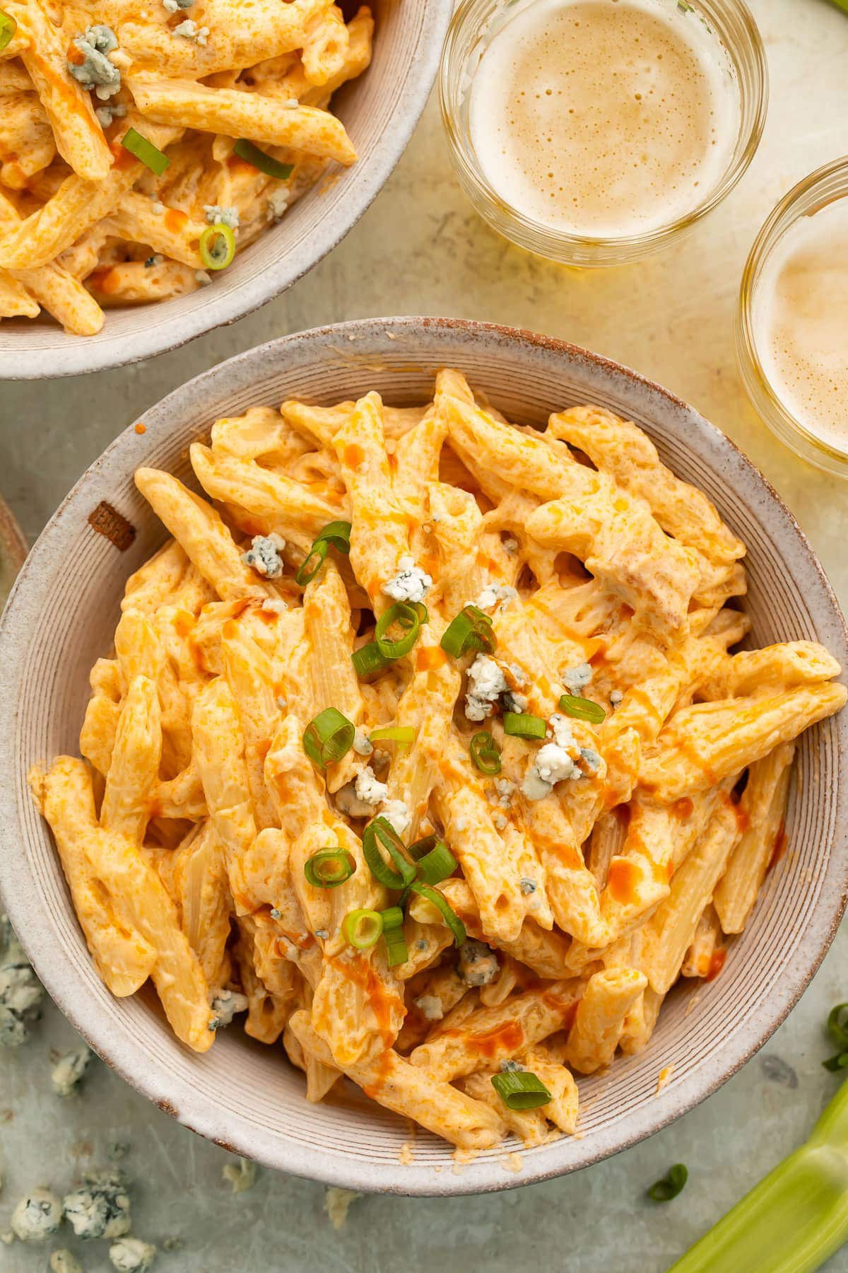 A bowl of buffalo chicken alfredo with penne pasta and grilled chicken strips.