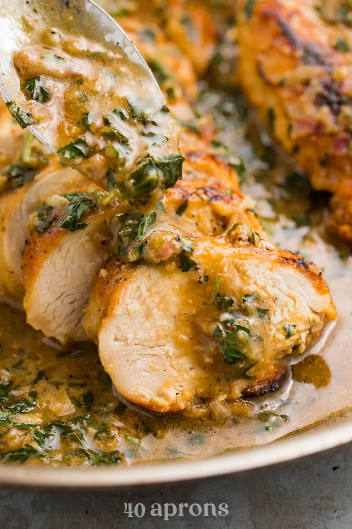 Sliced chicken breast smothered in a rich garlic herb butter sauce.