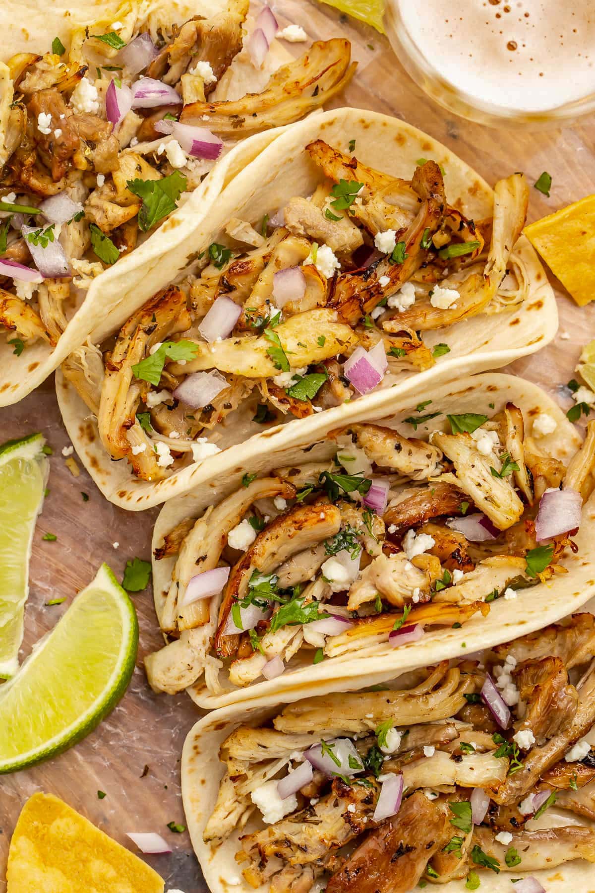 Close-up of flour tortilla tacos holding chicken carnitas cooked in the Instant Pot.