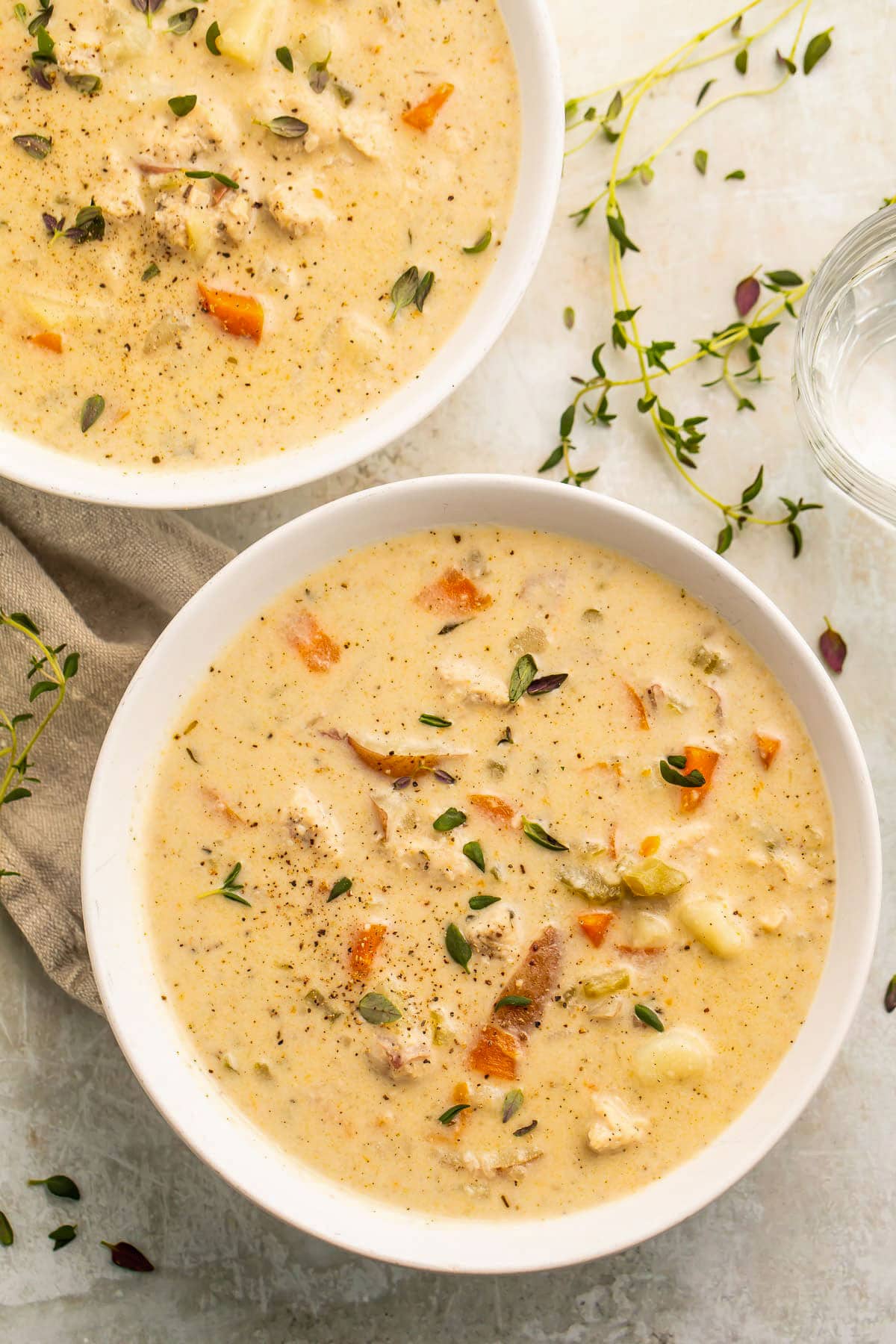 Two bowls of Instant Pot chicken pot pie soup on a table.