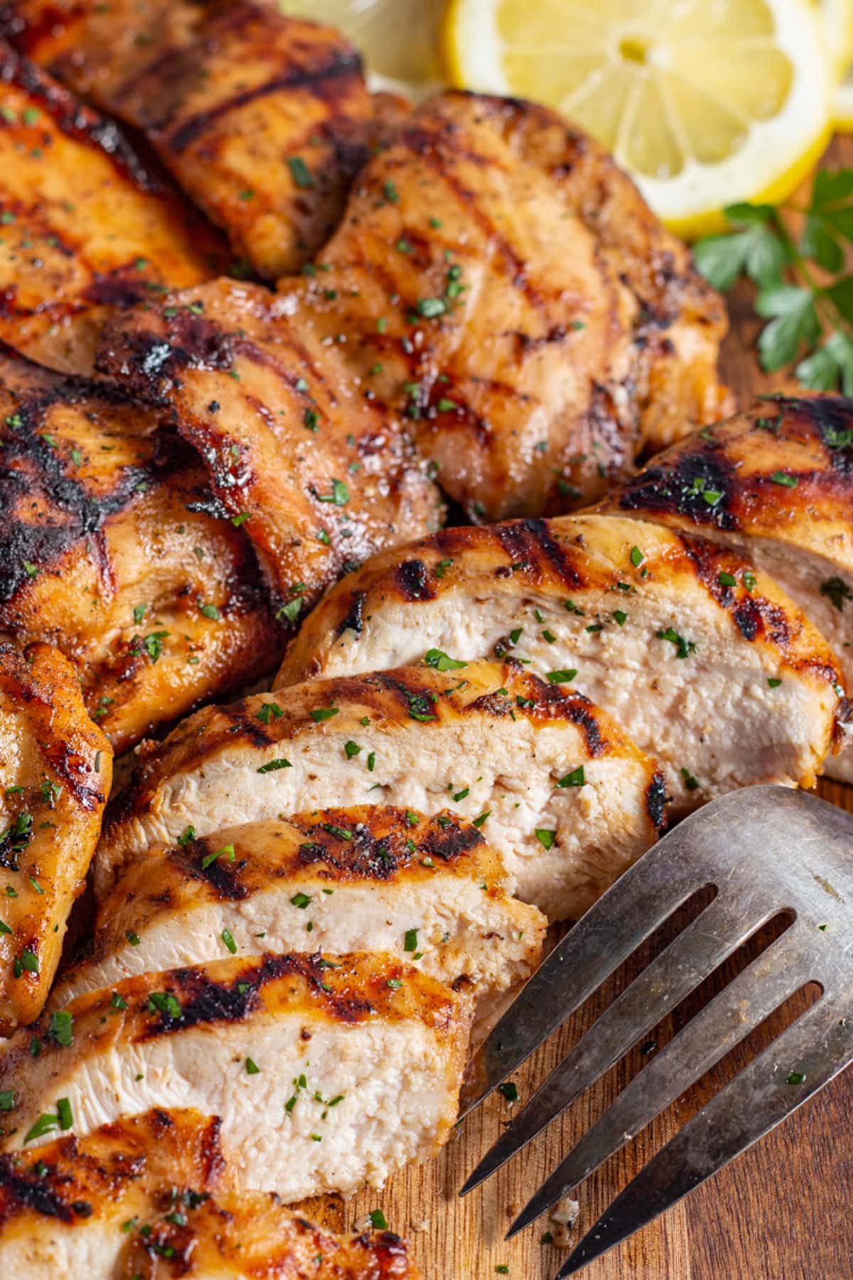 Juicy mesquite grilled chicken, with a chicken breast sliced thick to show the inside meat.