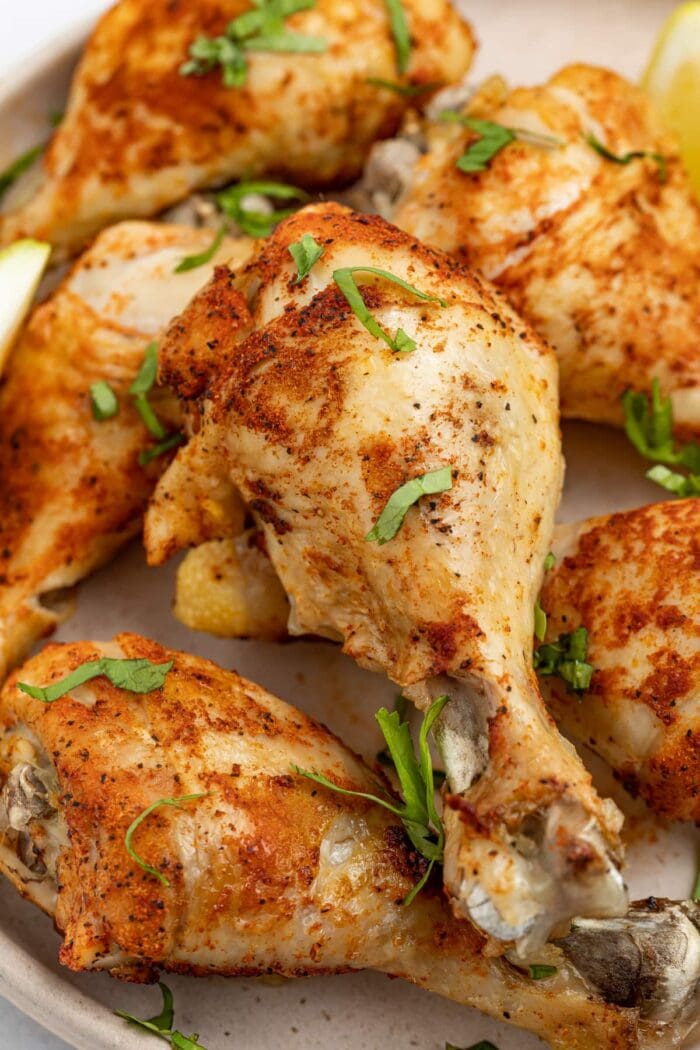 close up image of instant pot chicken legs with fresh parsley on top