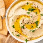Close up photo of baba ganoush in a white bowl