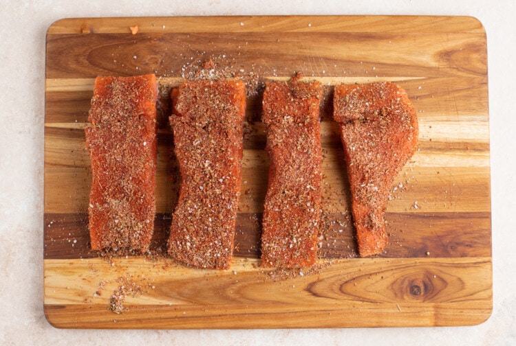 Spice rubbed salmon filets on a cutting board
