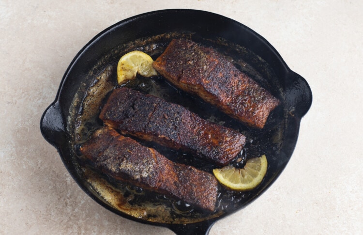 Blackened salmon filets in cast iron skillet