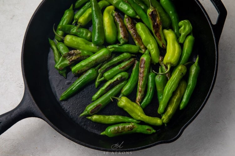 Shishito peppers in large cast iron skillet