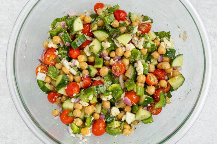 Mediterranean chickpea salad in a large glass mixing bowl.