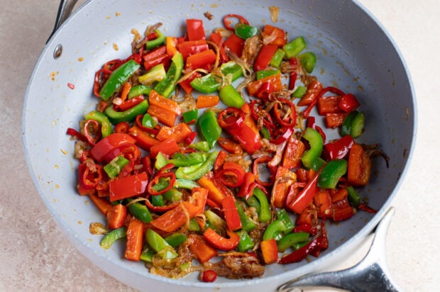 Bell peppers and aromatics for Hunan beef in large frying pan