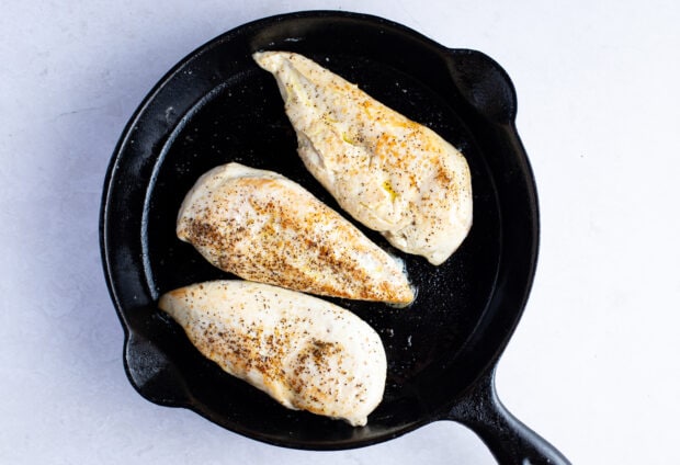 Seared chicken breasts in cast iron skillet