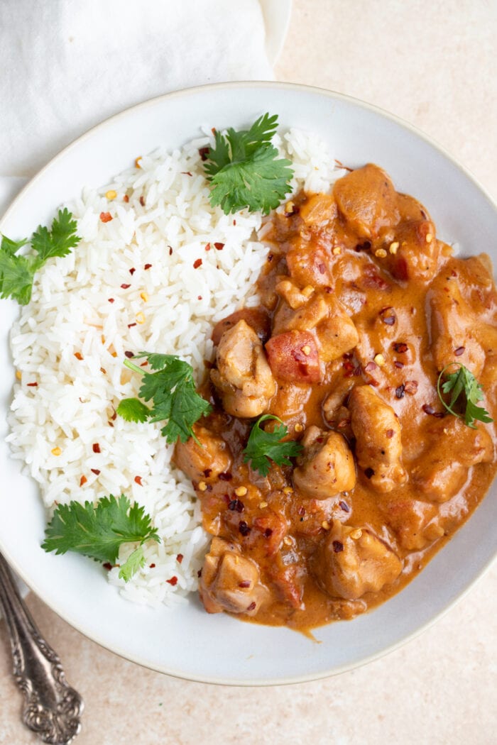 Peanut butter chicken in a white bowl set on top of a napkin