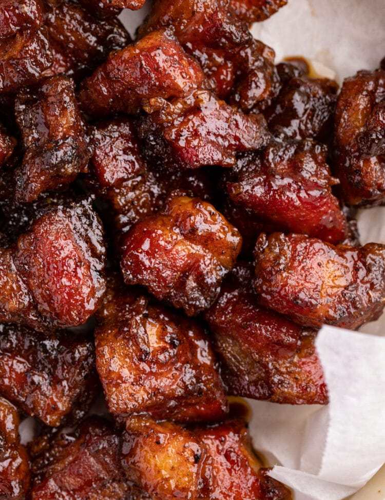 Pork belly burnt ends on white parchment paper.