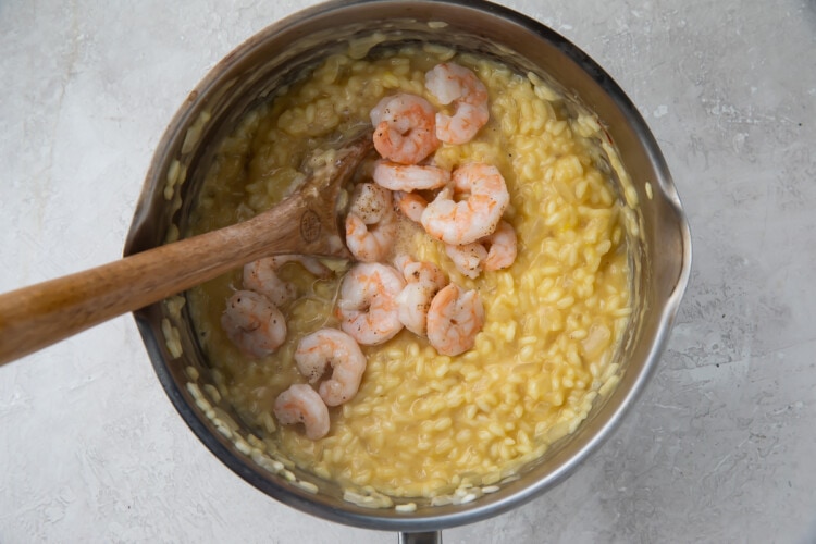 Shrimp and arborio rice in a large saucepan