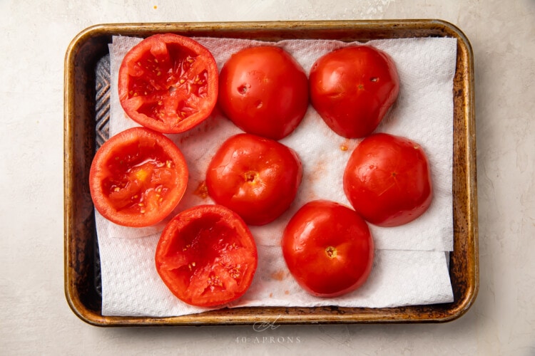 Halved tomatoes on baking sheet