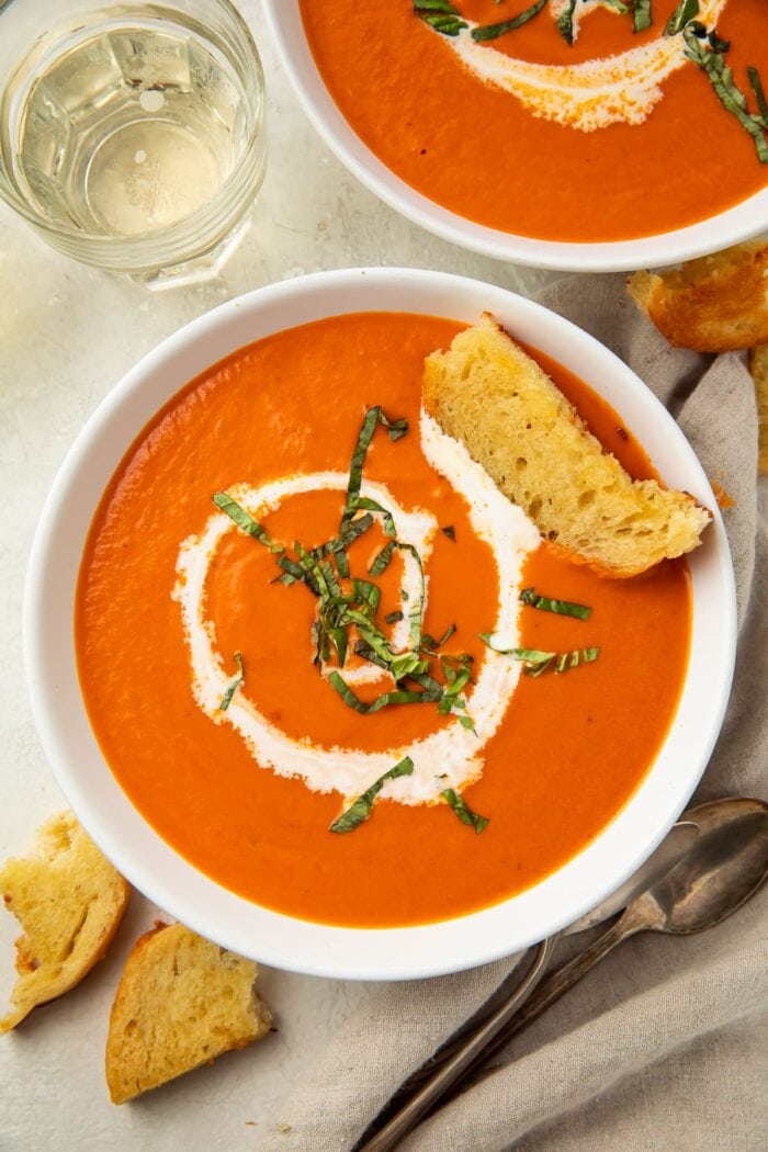 Overhead photo of tomato bisque with a swirl of heavy cream