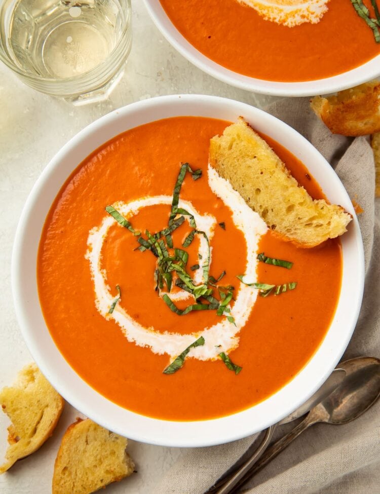 Overhead photo of tomato bisque with a swirl of heavy cream