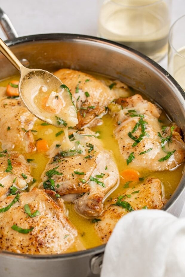 chicken fricassee in a skillet with a spoon